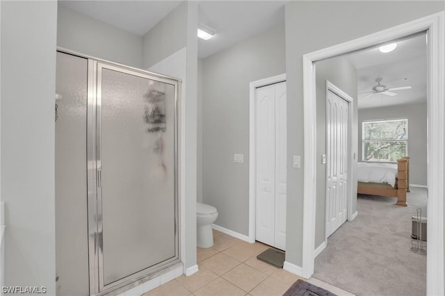 bathroom featuring an enclosed shower, tile patterned floors, toilet, and ceiling fan