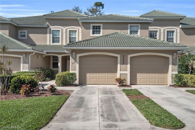 mediterranean / spanish-style home with a garage