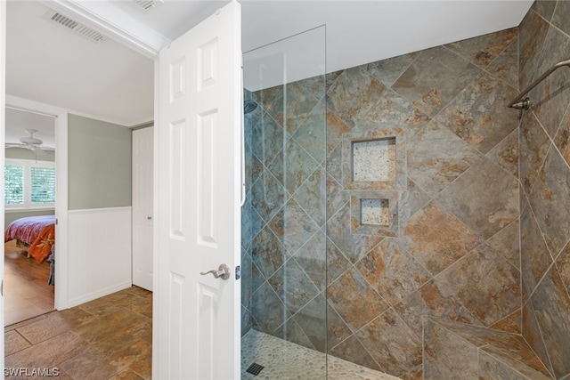 bathroom featuring tile flooring, ceiling fan, and a tile shower