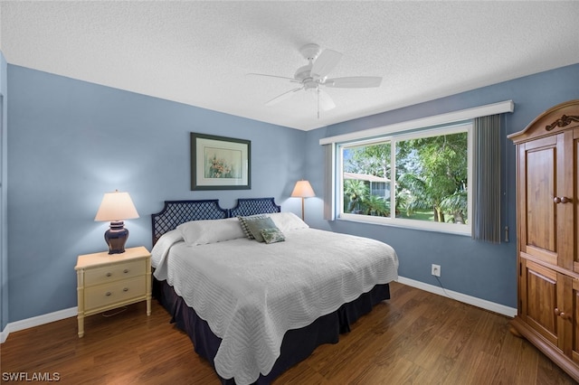 bedroom featuring ceiling fan, dark wood-type flooring, and a textured ceiling