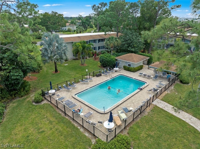 view of pool featuring a patio area and a yard