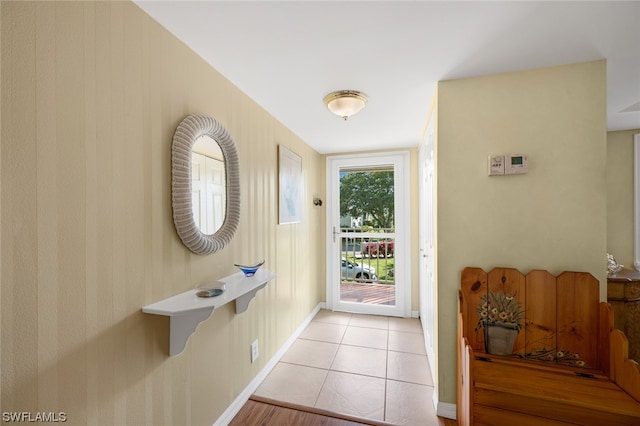 doorway to outside featuring light tile floors