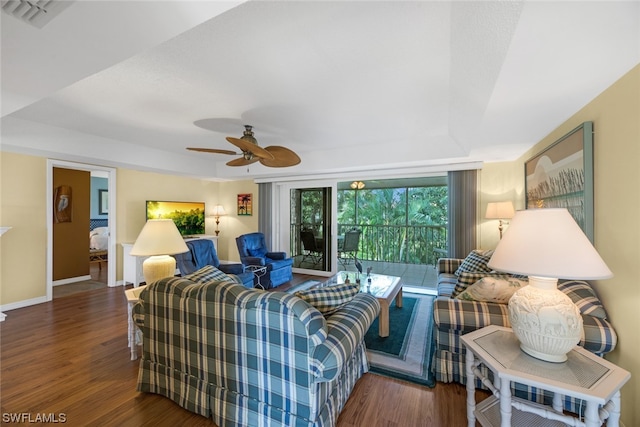 living room with ceiling fan and dark hardwood / wood-style floors