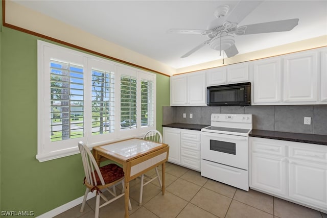 kitchen featuring white range with electric stovetop, white cabinets, backsplash, light tile floors, and ceiling fan