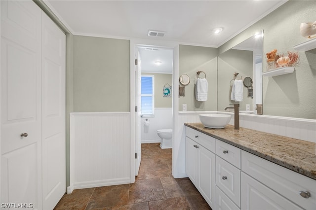 bathroom featuring ornamental molding, vanity, toilet, and tile flooring