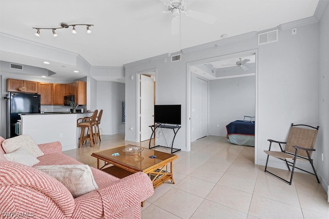 living room featuring light tile floors, rail lighting, ceiling fan, and ornamental molding