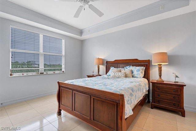 tiled bedroom featuring a tray ceiling, ceiling fan, and crown molding