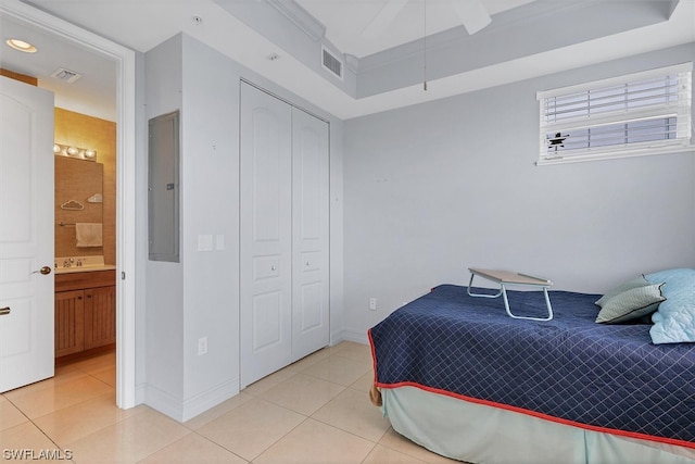 bedroom featuring ceiling fan, a closet, light tile floors, and connected bathroom