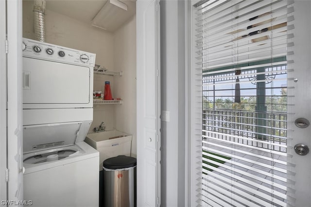 clothes washing area featuring stacked washer / dryer