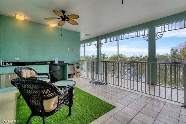 view of patio with ceiling fan and sink