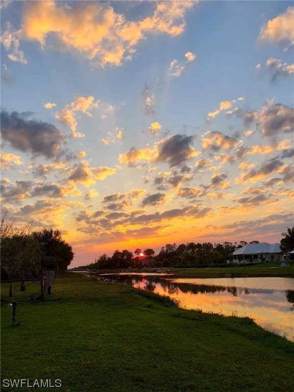 yard at dusk with a water view