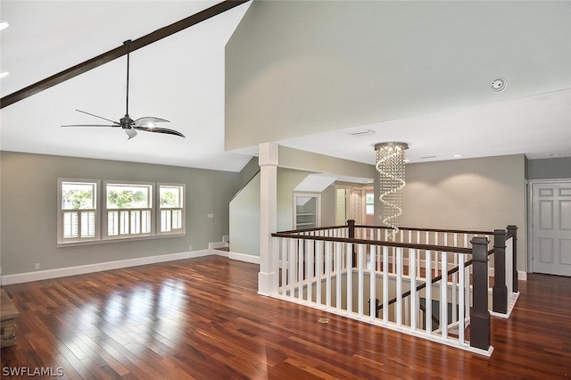 interior space with dark hardwood / wood-style flooring, ceiling fan with notable chandelier, and high vaulted ceiling