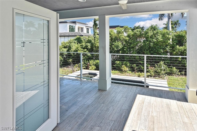 entryway featuring a wall of windows, plenty of natural light, and wood finished floors