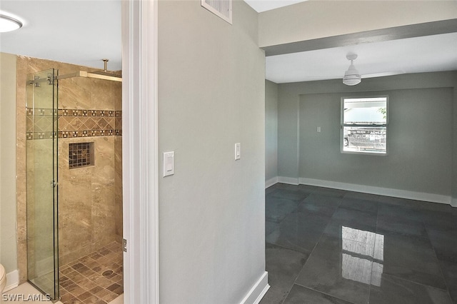 bathroom featuring visible vents, a shower stall, and baseboards