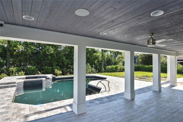 view of pool featuring an in ground hot tub, a wooden deck, and ceiling fan