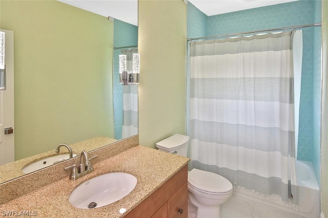 bathroom with shower / bath combo with shower curtain, vanity, and toilet