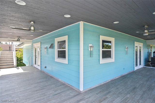 wooden terrace featuring french doors and ceiling fan