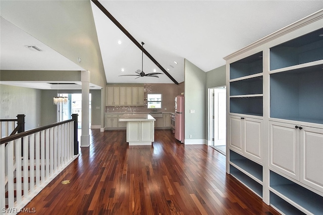 kitchen featuring lofted ceiling, dark wood-style flooring, plenty of natural light, and a center island