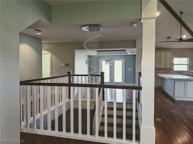 hallway featuring dark hardwood / wood-style flooring and a chandelier