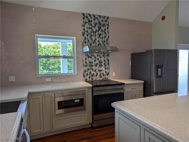 kitchen with ventilation hood, decorative backsplash, light stone counters, stainless steel appliances, and dark wood-type flooring