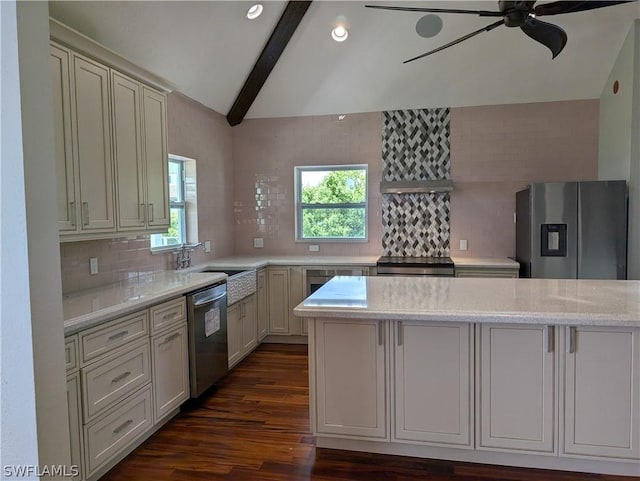 kitchen featuring sink, appliances with stainless steel finishes, vaulted ceiling with beams, a wealth of natural light, and light stone countertops