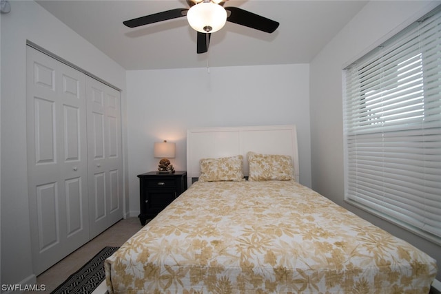 bedroom featuring a closet, ceiling fan, and carpet