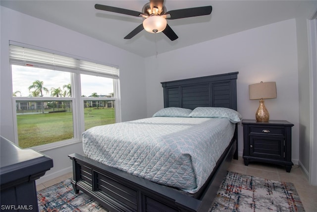 tiled bedroom with ceiling fan