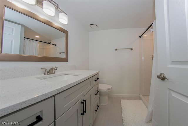 bathroom with toilet, tile flooring, curtained shower, and oversized vanity