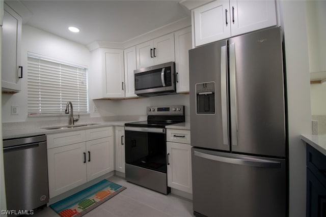 kitchen featuring stainless steel appliances, light tile flooring, sink, white cabinets, and light stone counters