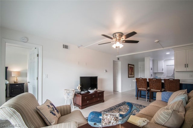 tiled living room with ceiling fan