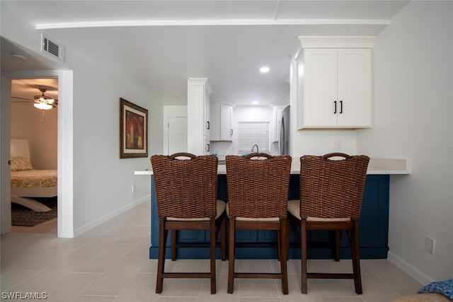 tiled dining room featuring ceiling fan