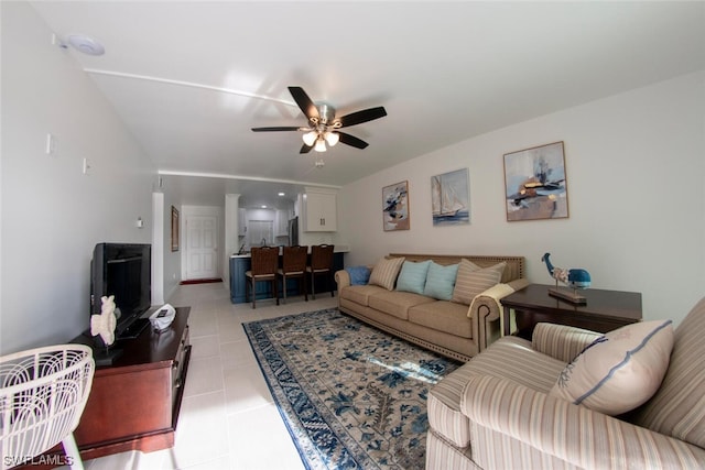 living room with light tile floors and ceiling fan