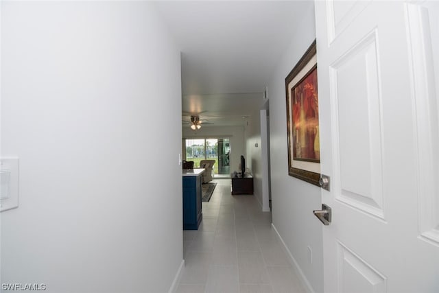 hallway featuring light tile flooring