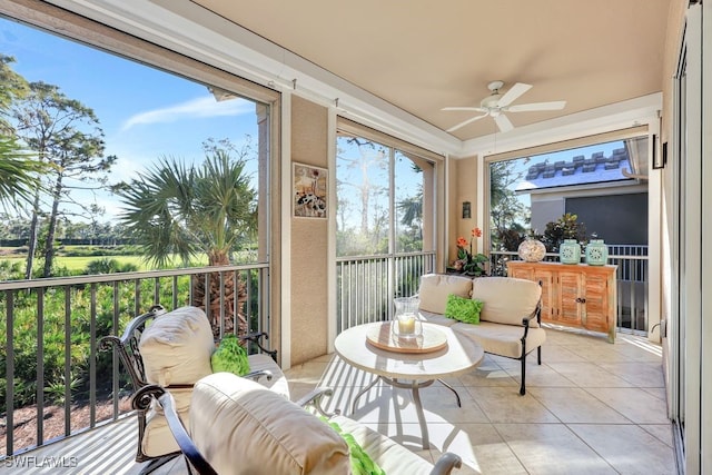 sunroom / solarium featuring ceiling fan