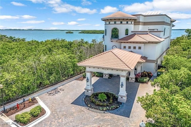 rear view of property with a garage and a water view