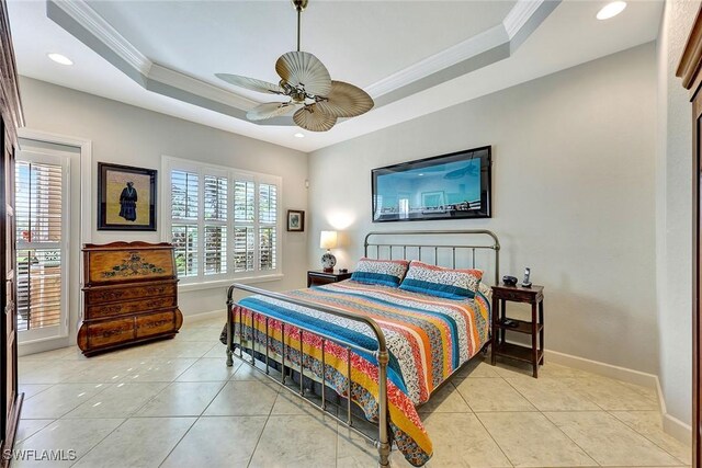 tiled bedroom with a raised ceiling, ceiling fan, and ornamental molding