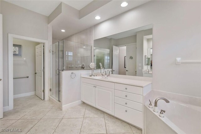 bathroom featuring vanity, tile patterned floors, and plus walk in shower