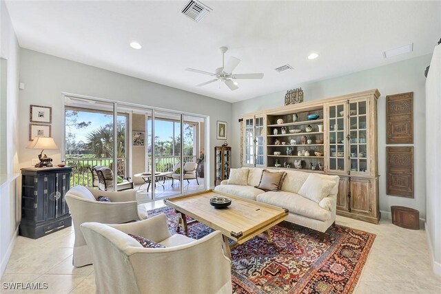 tiled living room featuring ceiling fan