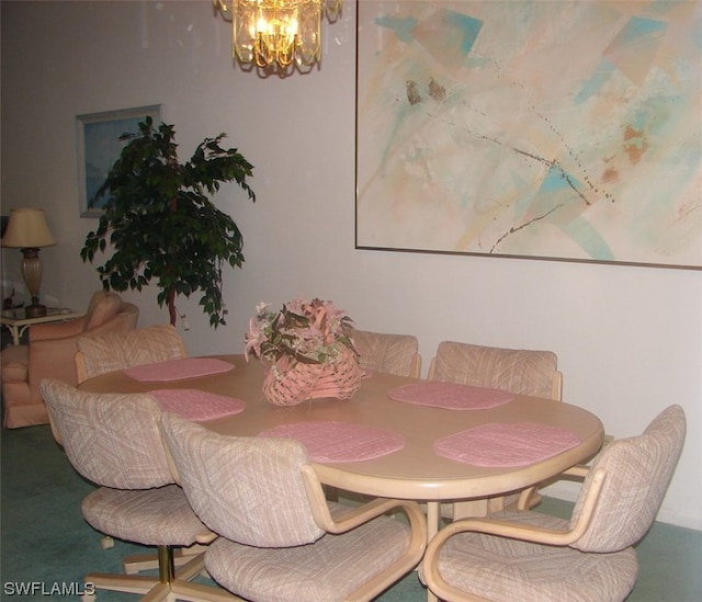 carpeted dining area featuring a chandelier