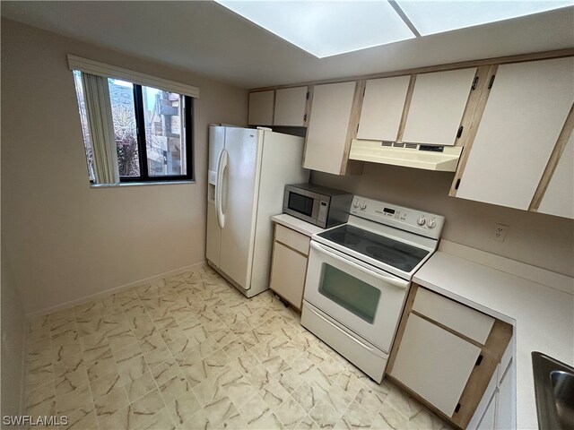 kitchen featuring white appliances and light tile flooring