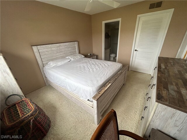 carpeted bedroom featuring connected bathroom and ceiling fan