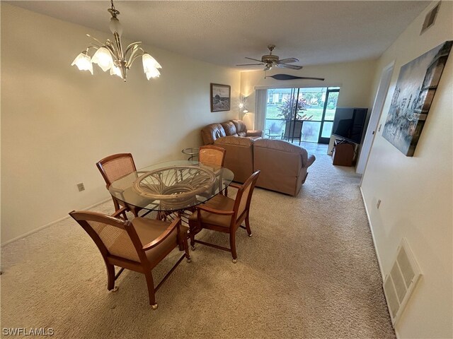 dining area with light colored carpet and ceiling fan with notable chandelier