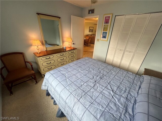 bedroom featuring a closet and light carpet