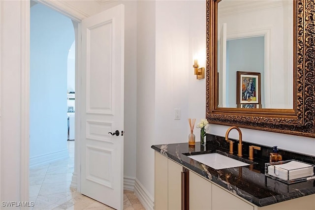 bathroom featuring baseboards and vanity