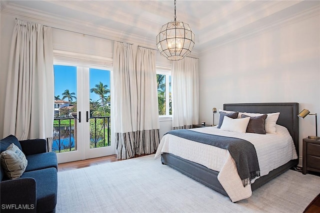 bedroom with an inviting chandelier, access to outside, french doors, and ornamental molding