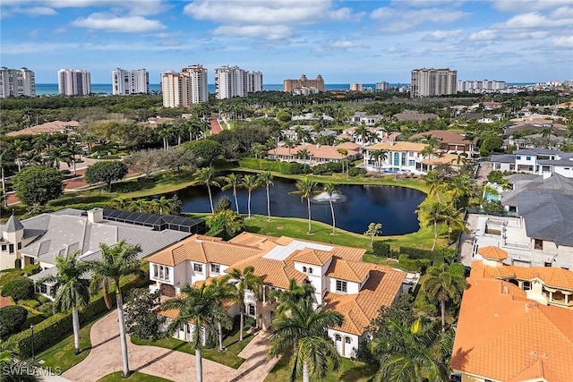 drone / aerial view with a residential view, a view of city, and a water view