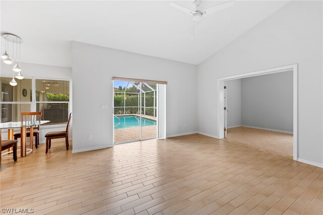 living room featuring high vaulted ceiling, ceiling fan, and light hardwood / wood-style flooring