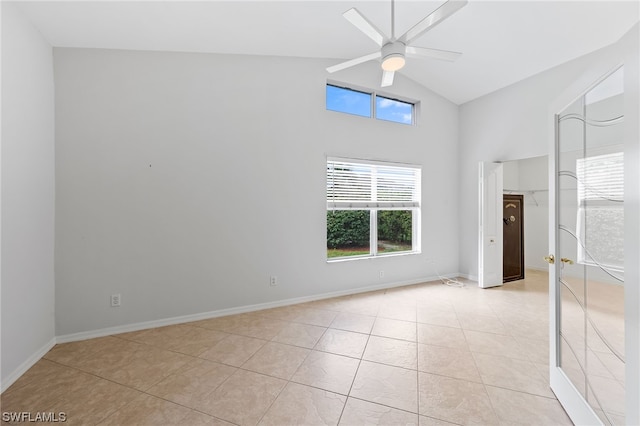 unfurnished bedroom featuring high vaulted ceiling, ceiling fan, and light tile flooring