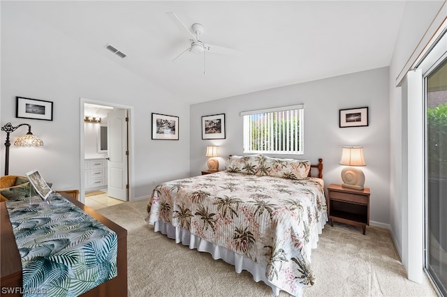 carpeted bedroom featuring lofted ceiling, ensuite bath, and ceiling fan