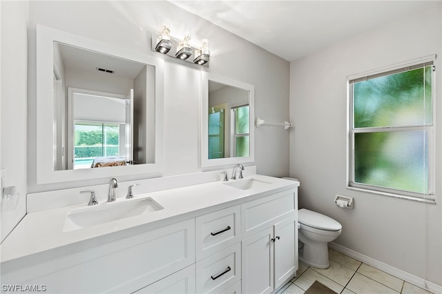 bathroom with large vanity, dual sinks, tile floors, and toilet